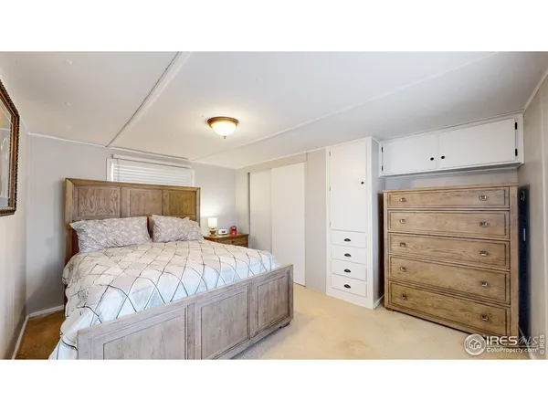 a bedroom with a bed and cabinet