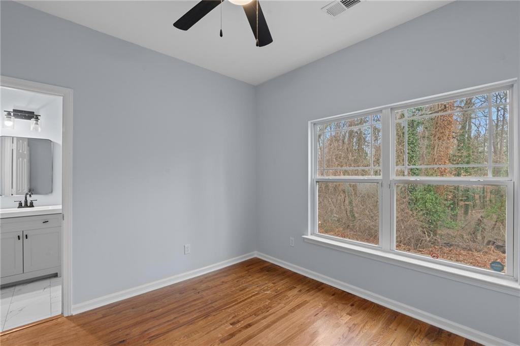 49 Harlan Road Southwest Atlanta, GA 30311 - Photo 12 of 38 wooden floor in an empty room with a window