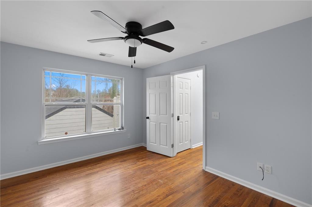 49 Harlan Road Southwest Atlanta, GA 30311 - Photo 33 of 38 a view of an empty room with wooden floor and a window