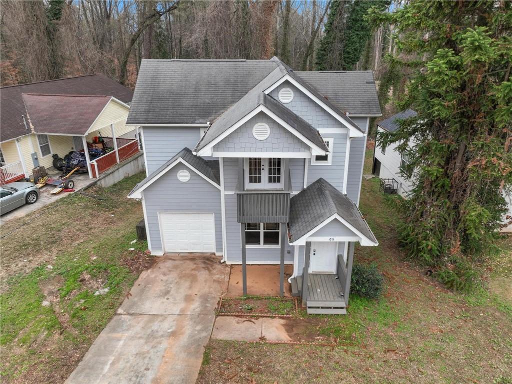 49 Harlan Road Southwest Atlanta, GA 30311 - Photo 34 of 38 a front view of a house with a yard and garage