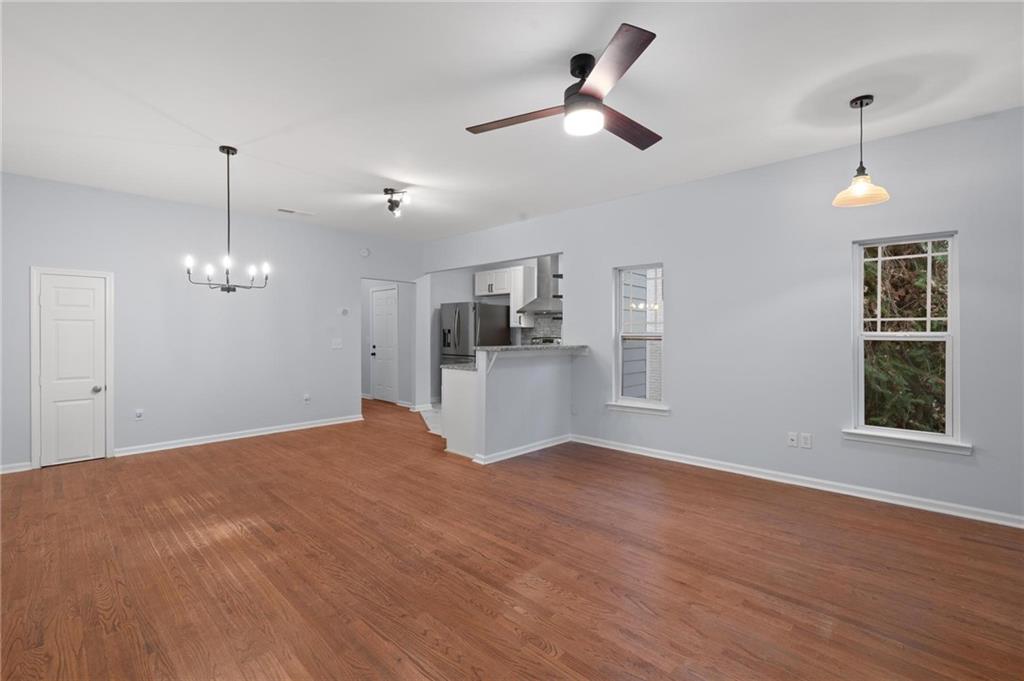 49 Harlan Road Southwest Atlanta, GA 30311 - Photo 6 of 38 a view of a kitchen with wooden floor and a ceiling fan