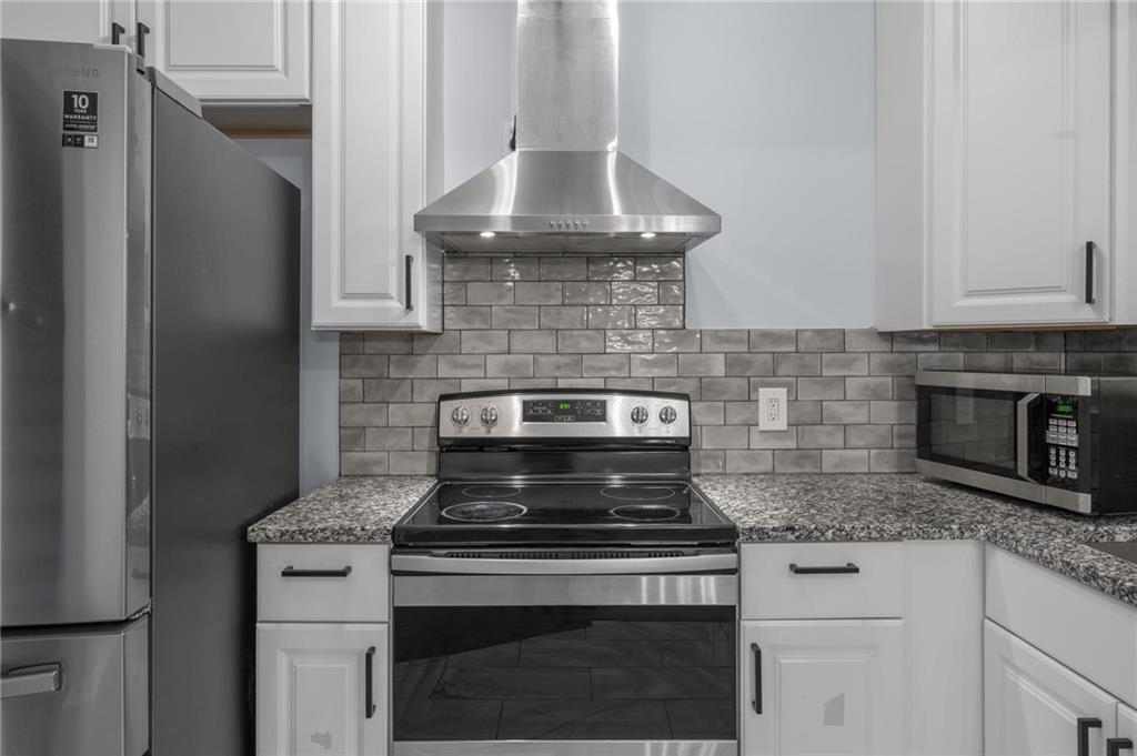 49 Harlan Road Southwest Atlanta, GA 30311 - Photo 9 of 38 a stove top oven sitting inside of a kitchen