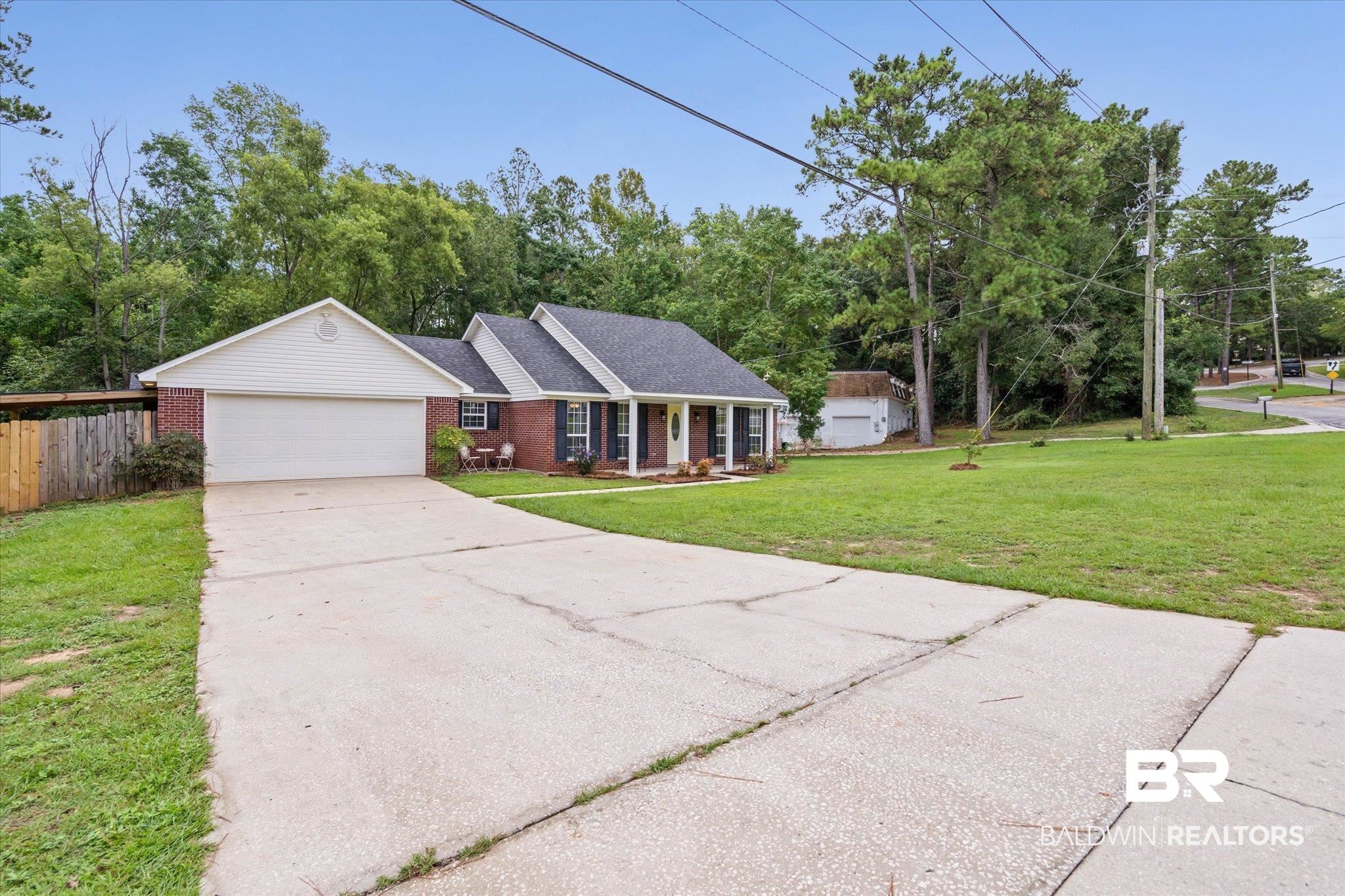 157 Bay View Drive Daphne, AL 36526 - Photo 18 of 22 Single story home with an attached garage, covered porch, brick siding, driveway, and roof with shingles