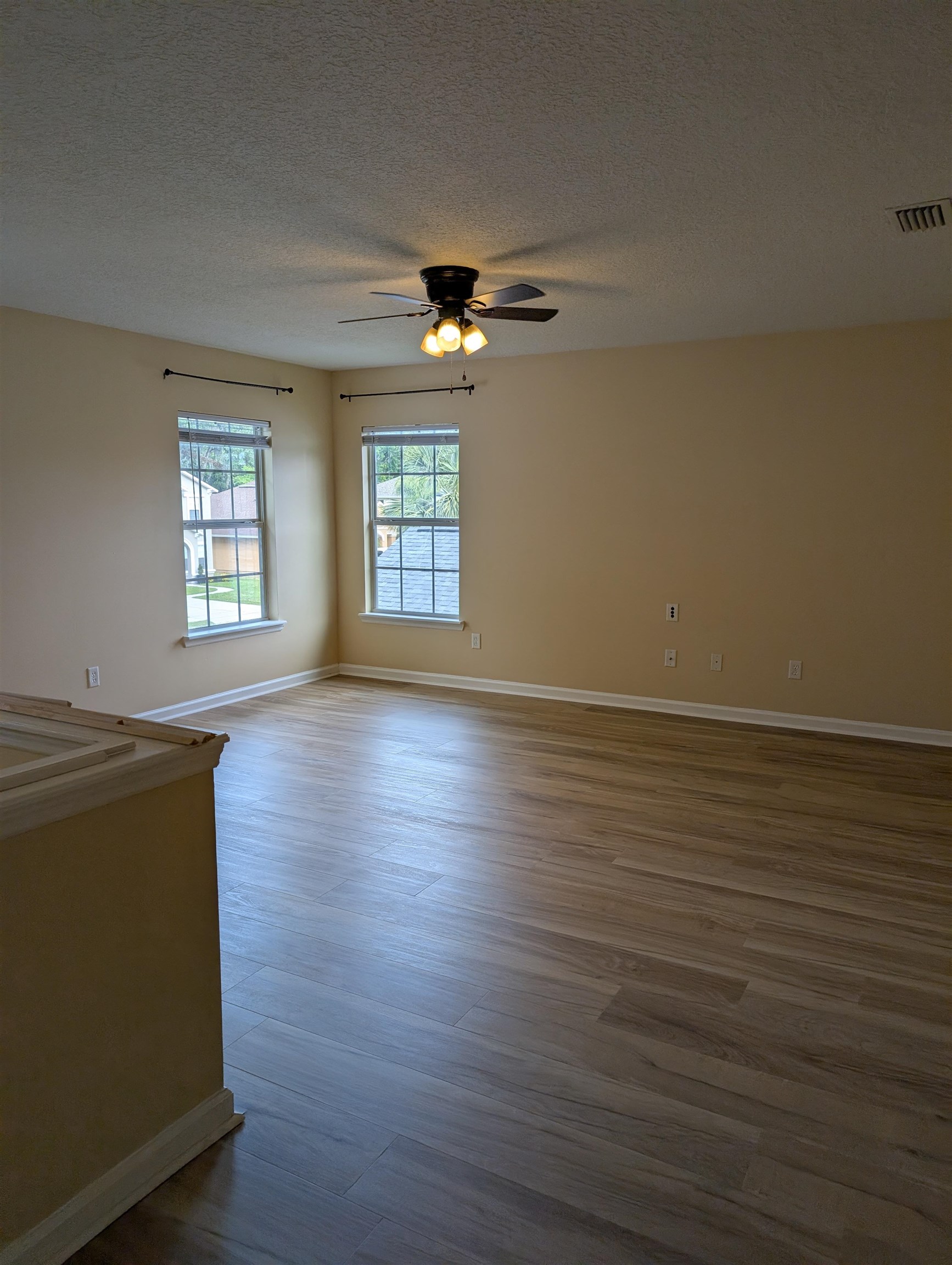 133 Camden Cay Drive St. Augustine, FL 32086 - Photo 13 of 33 wooden floor in an empty room with a window
