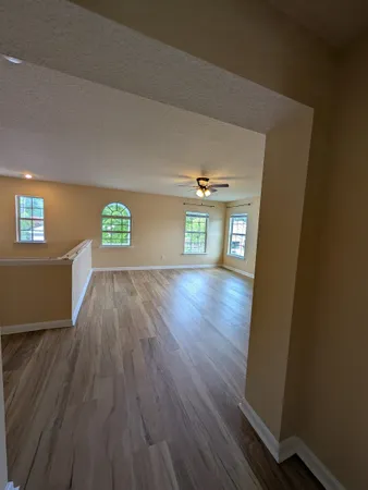 a view of an empty room and wooden floor