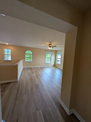 a view of an empty room and wooden floor