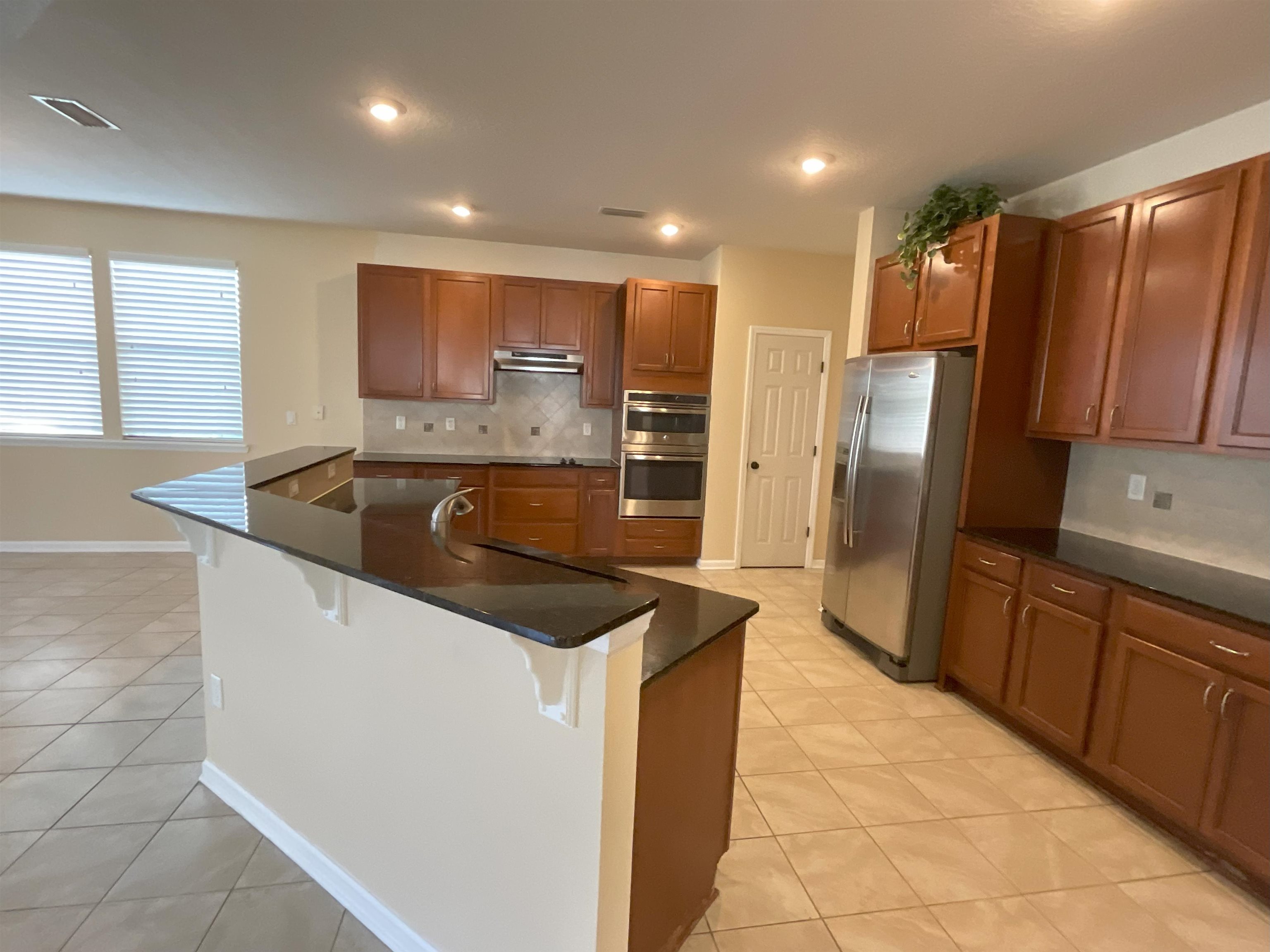 133 Camden Cay Drive St. Augustine, FL 32086 - Photo 2 of 33 a kitchen with stainless steel appliances granite countertop a sink and a refrigerator