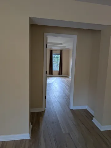 an empty room with wooden floor and closet