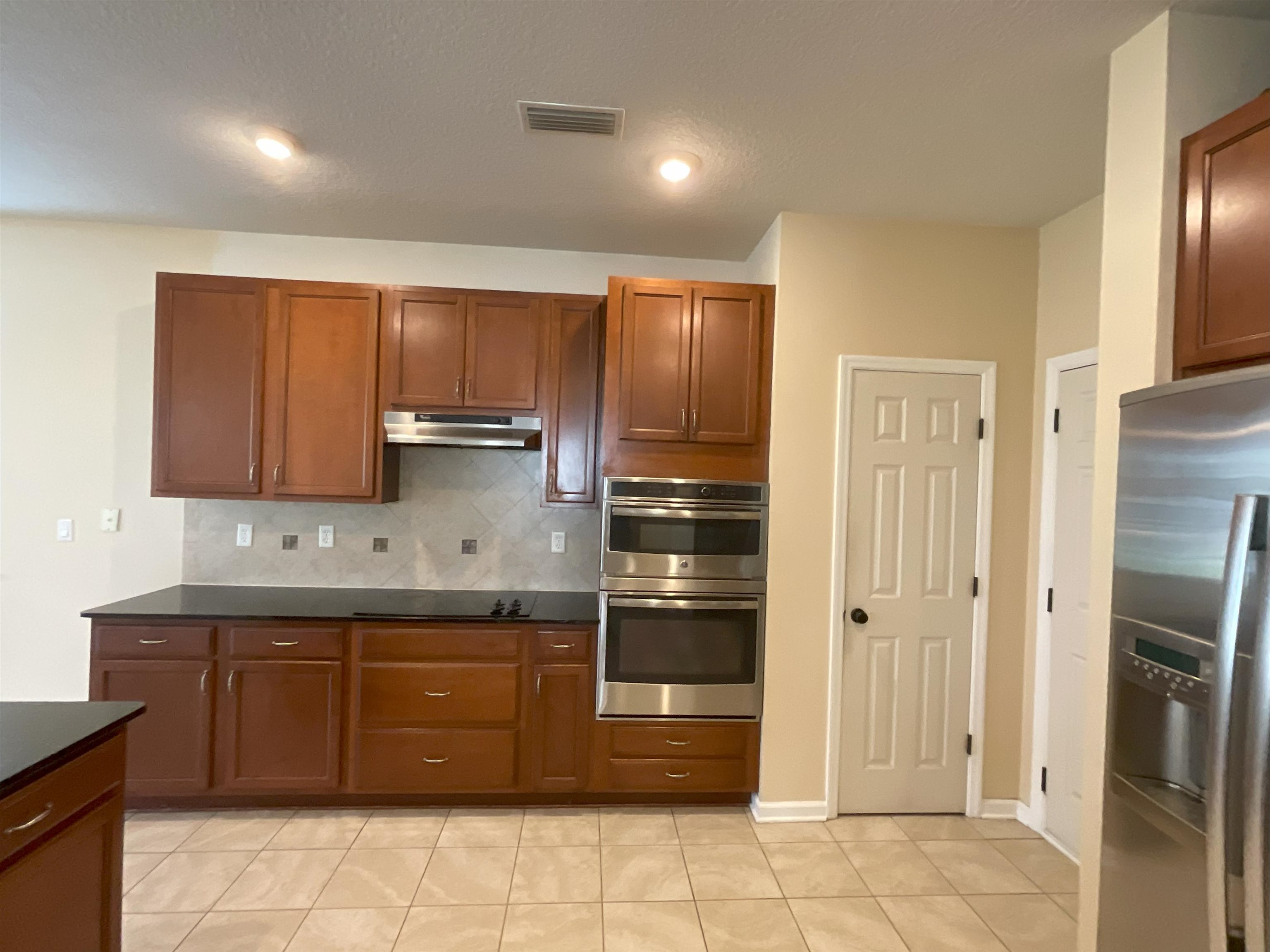 133 Camden Cay Drive St. Augustine, FL 32086 - Photo 5 of 33 a kitchen with stainless steel appliances granite countertop a stove a refrigerator and a sink