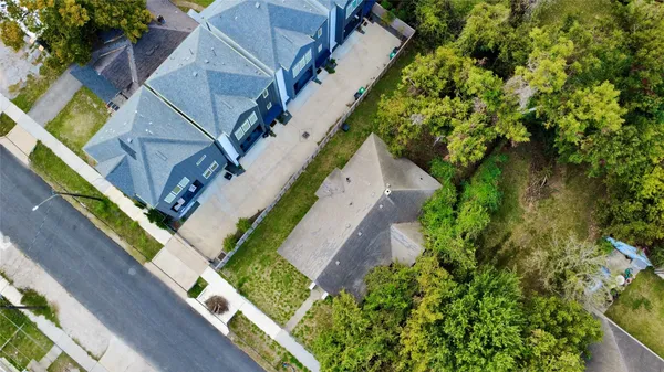 an aerial view of residential houses with trees