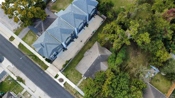 an aerial view of multiple houses with a yard