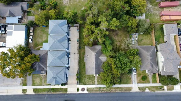 aerial view of a house with a yard and large tree