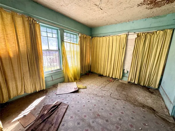 a view of a room with wooden floor and furniture
