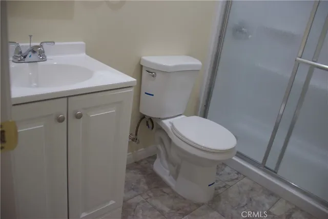 a white toilet sitting next to a bathroom sink