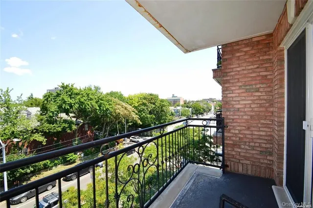 a view of a balcony with wooden benches