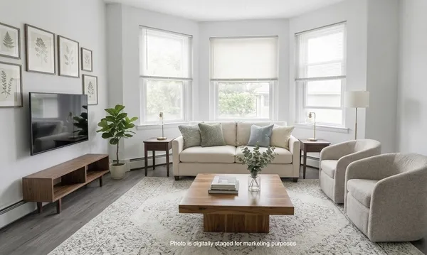 a living room with furniture fireplace and window