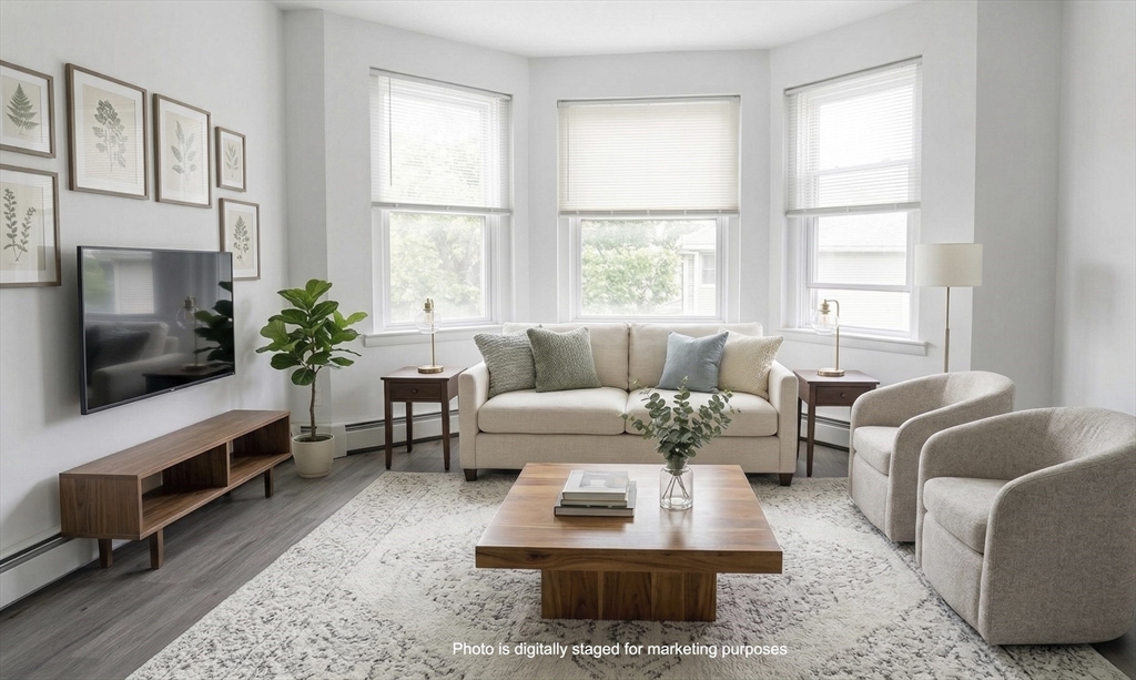 a living room with furniture fireplace and window