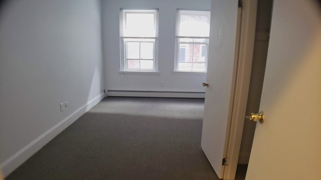 25 Chester Street, Unit 3 Boston, MA 02134 - Photo 7 of 14 an empty room with windows