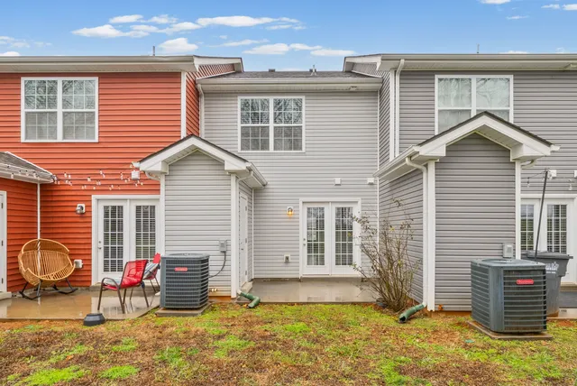 a view of a house with a patio and a yard