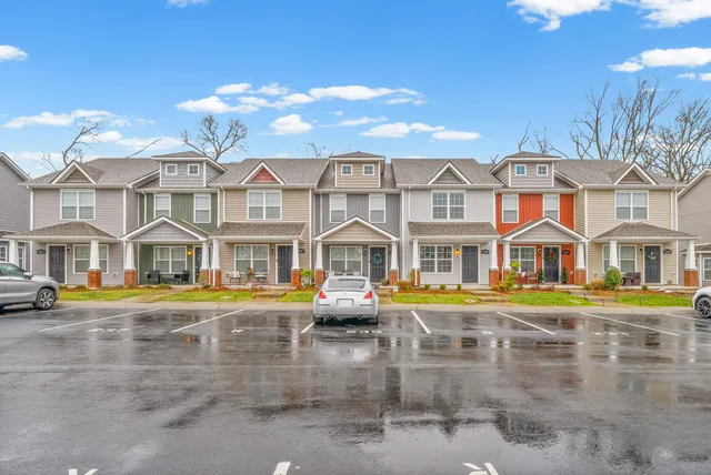 a front view of residential houses with yard and swimming pool