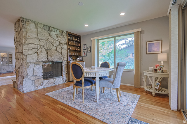 2924 Robidoux Road Sandy, UT 84093 - Photo 32 of 68 Hardwood flooring, stone fireplace, built-in shelving, large window, and recessed lighting