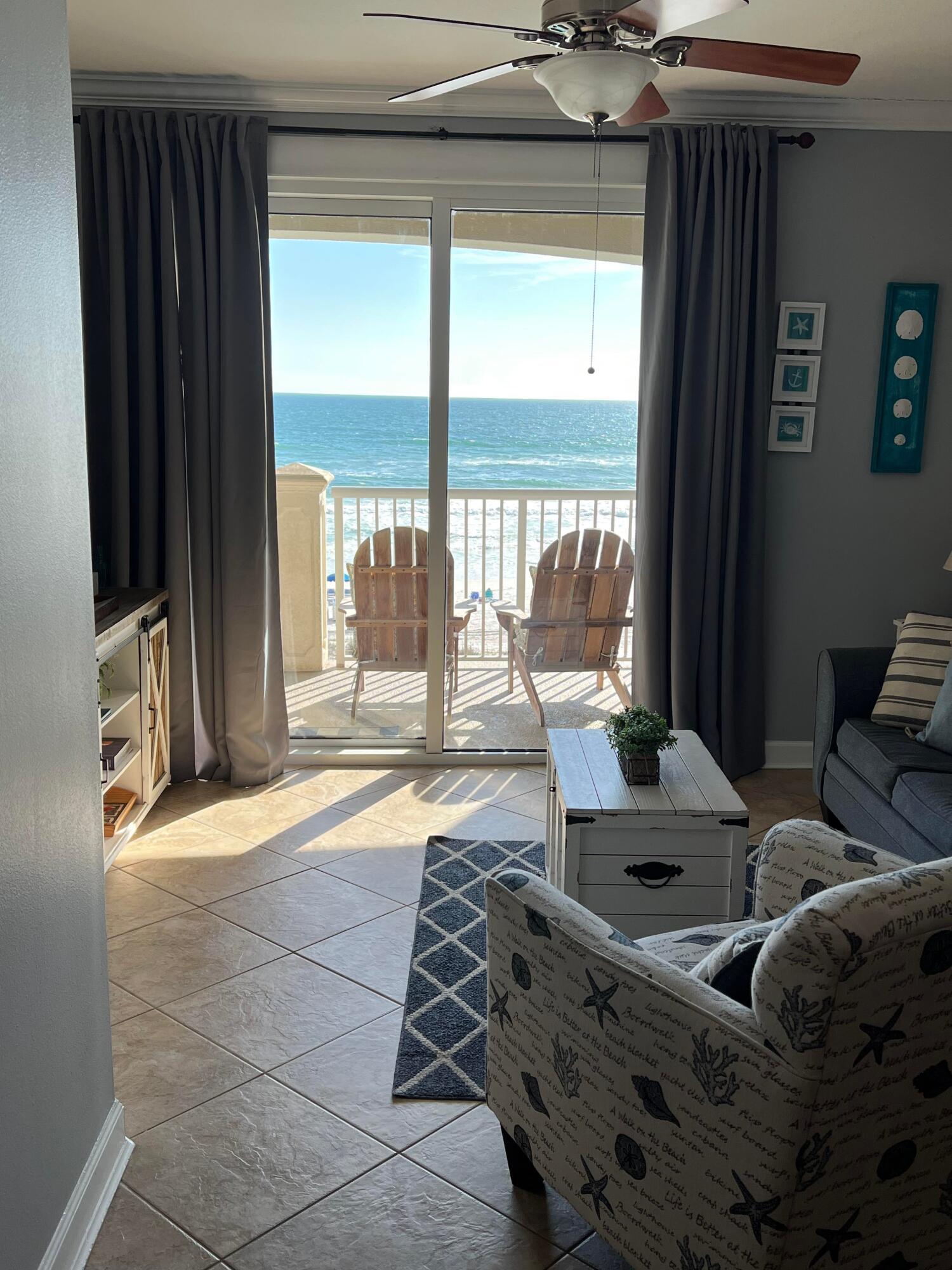 11807 Front Beach Road, Unit 1402 Panama City Beach, FL 32407 - Photo 13 of 37 a bedroom with furniture and large windows