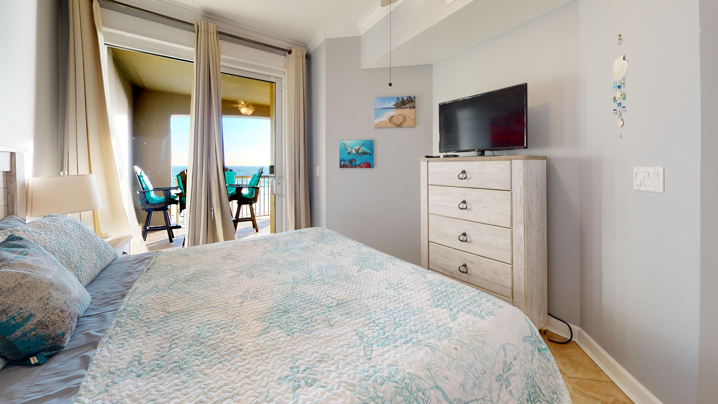 11807 Front Beach Road, Unit 1402 Panama City Beach, FL 32407 - Photo 20 of 37 a view of a bedroom with a flat tv screen and a bed