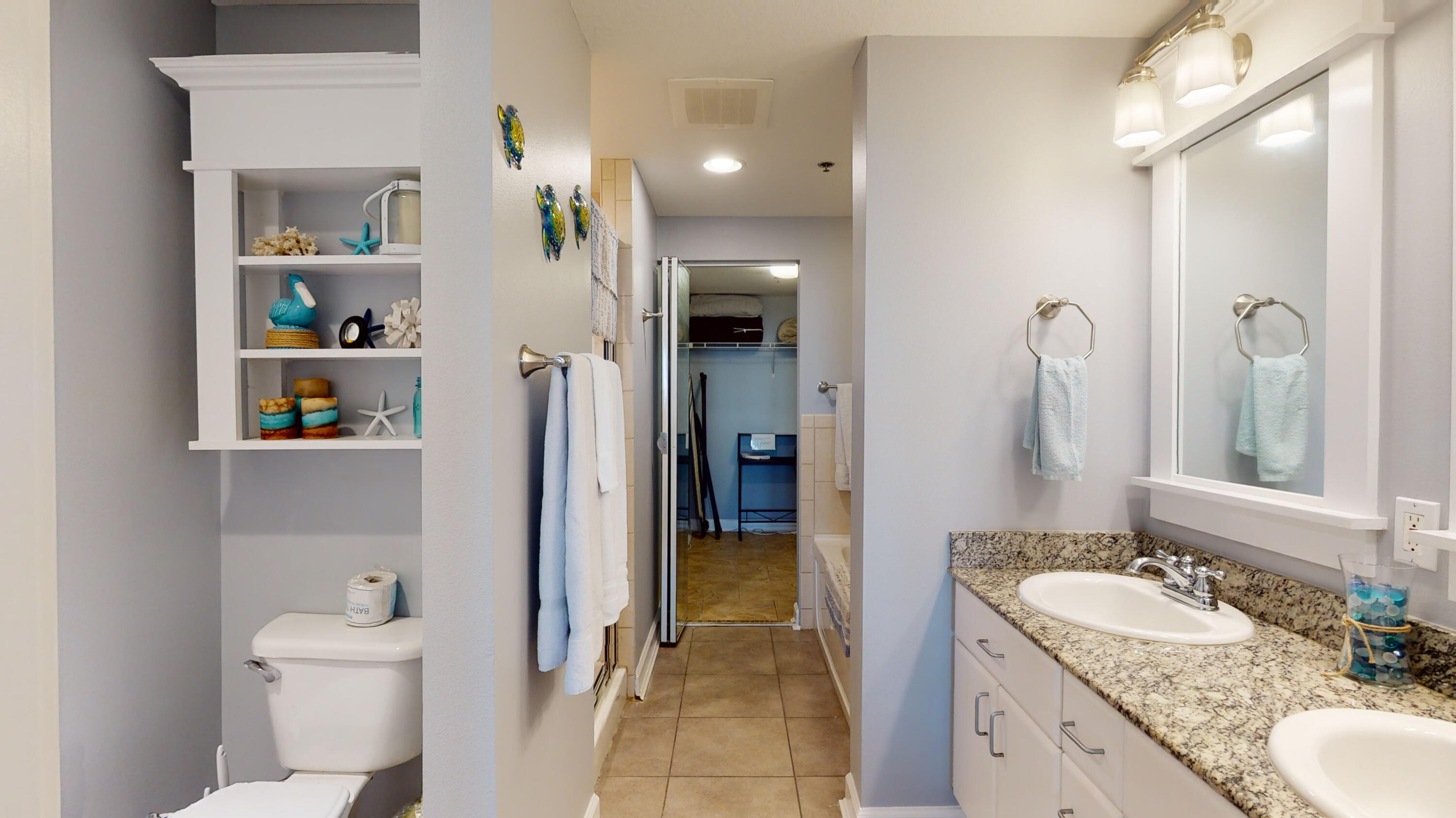 11807 Front Beach Road, Unit 1402 Panama City Beach, FL 32407 - Photo 23 of 37 a bathroom with a granite countertop sink toilet and shower