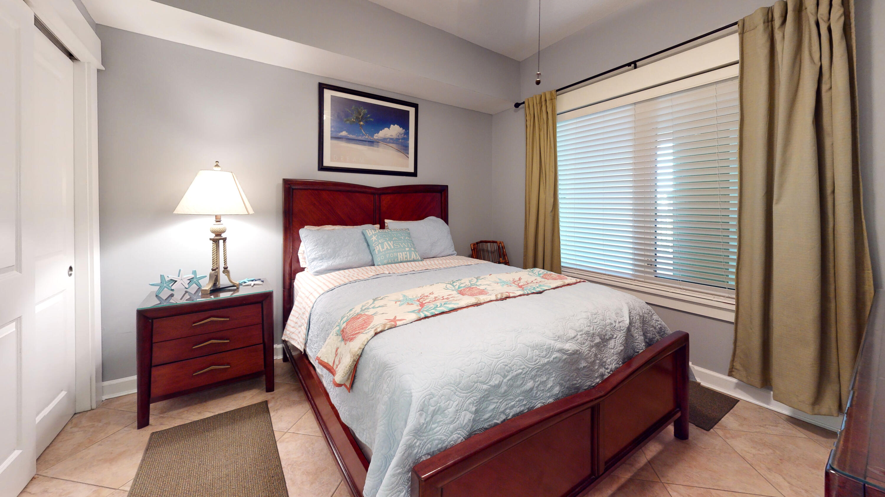 11807 Front Beach Road, Unit 1402 Panama City Beach, FL 32407 - Photo 25 of 37 a bed sitting in a bedroom next to a window