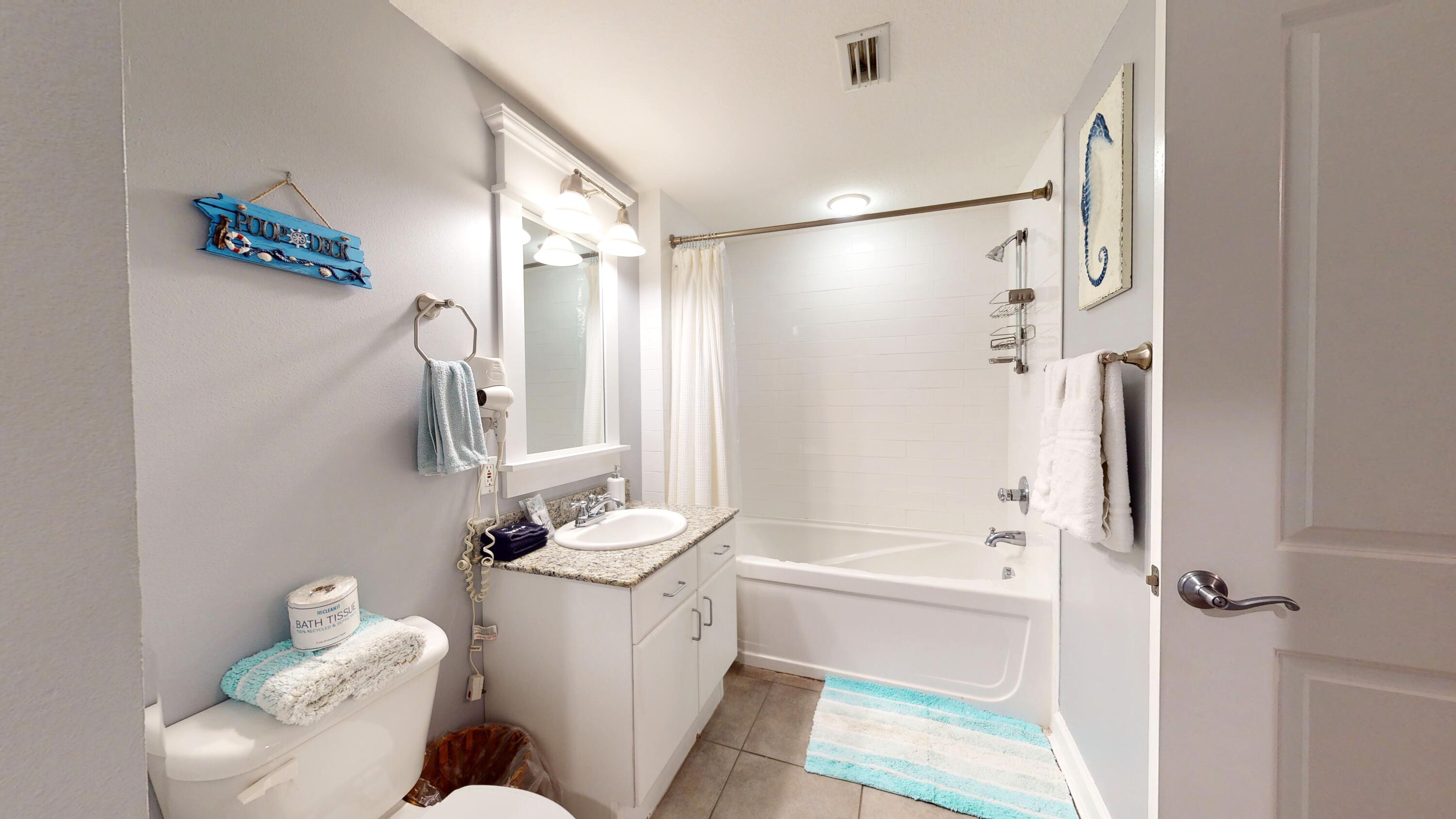 11807 Front Beach Road, Unit 1402 Panama City Beach, FL 32407 - Photo 27 of 37 a bathroom with a sink toilet and shower