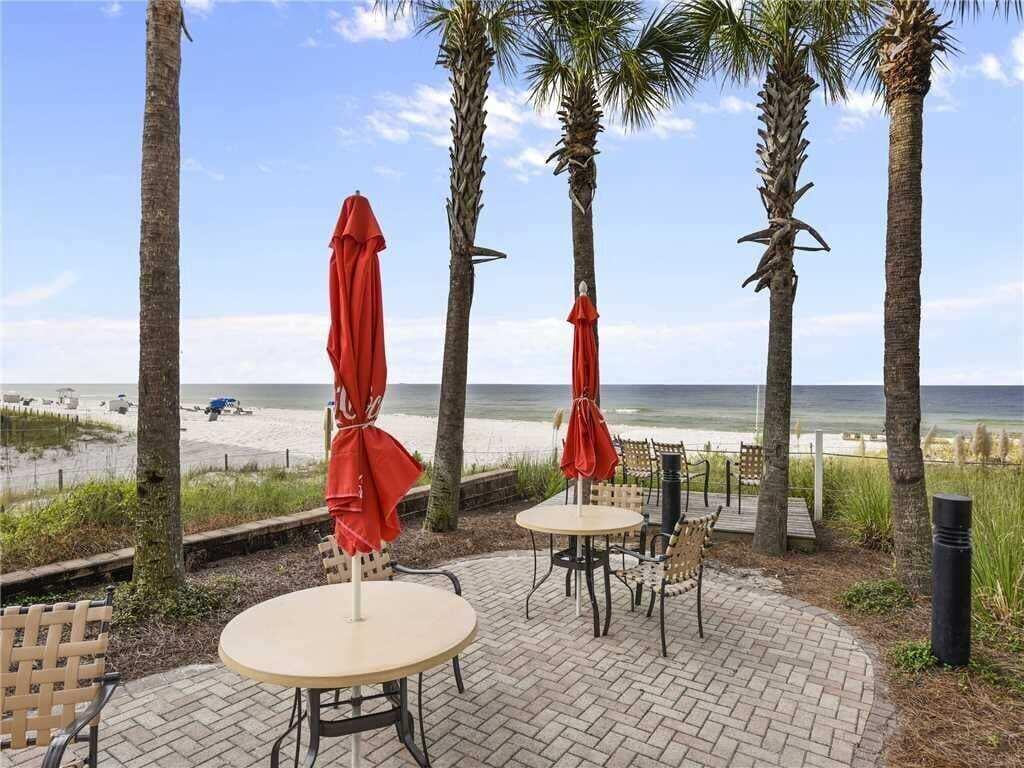 11807 Front Beach Road, Unit 1402 Panama City Beach, FL 32407 - Photo 28 of 37 a view of swimming pool with a table and chairs