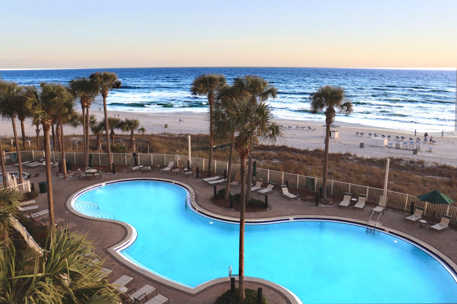 11807 Front Beach Road, Unit 1402 Panama City Beach, FL 32407 - Photo 3 of 37 a view of a swimming pool with a table and chairs