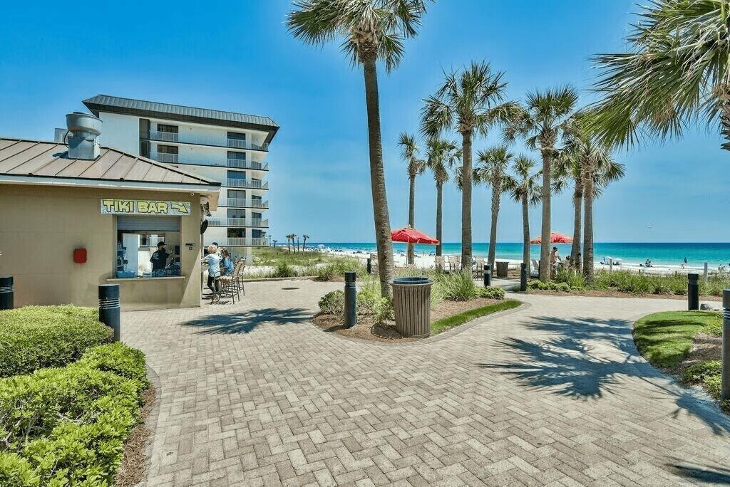 11807 Front Beach Road, Unit 1402 Panama City Beach, FL 32407 - Photo 31 of 37 a view of a house with backyard and trees