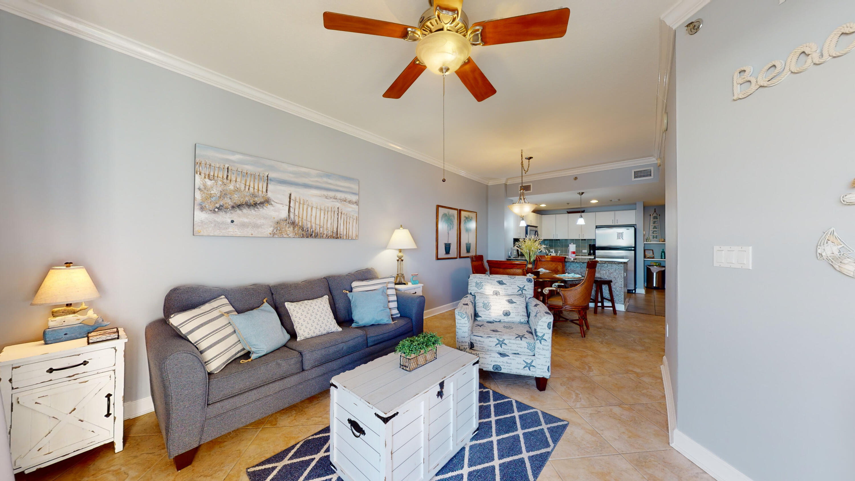 11807 Front Beach Road, Unit 1402 Panama City Beach, FL 32407 - Photo 5 of 37 a living room with furniture and a chandelier