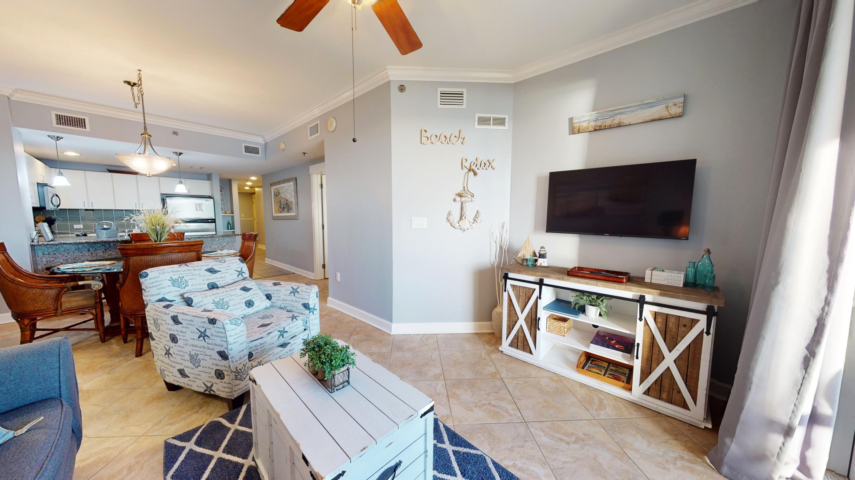 11807 Front Beach Road, Unit 1402 Panama City Beach, FL 32407 - Photo 8 of 37 a living room with furniture and a flat screen tv