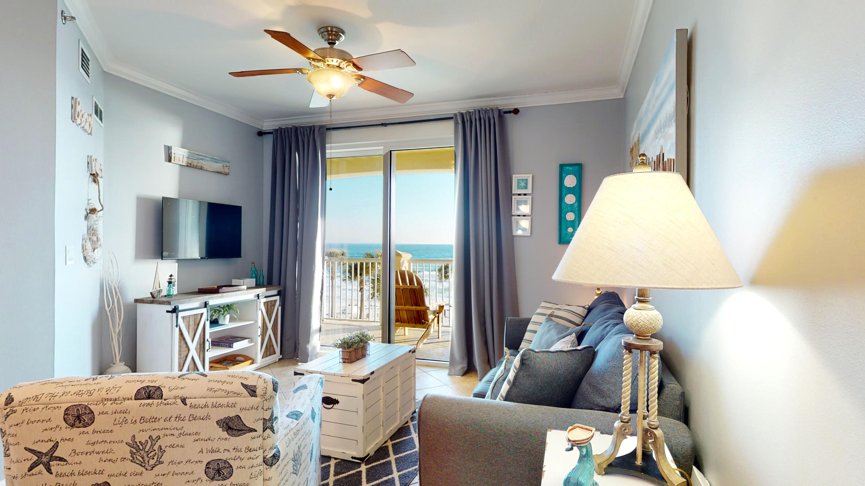 11807 Front Beach Road, Unit 1402 Panama City Beach, FL 32407 - Photo 10 of 37 a bedroom with a bed and a chandelier