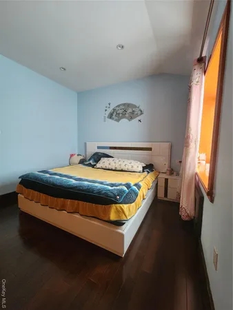 a bed sitting in a bedroom next to a window