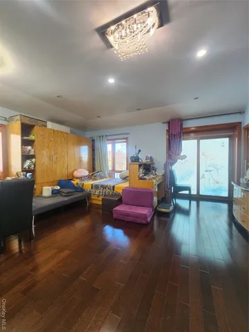 a bedroom with furniture window and wooden floor