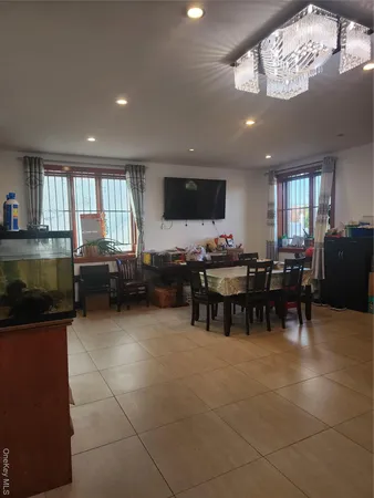 a living room with furniture a flat screen tv and kitchen view