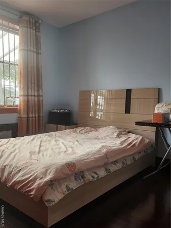 a bedroom with a bed and window