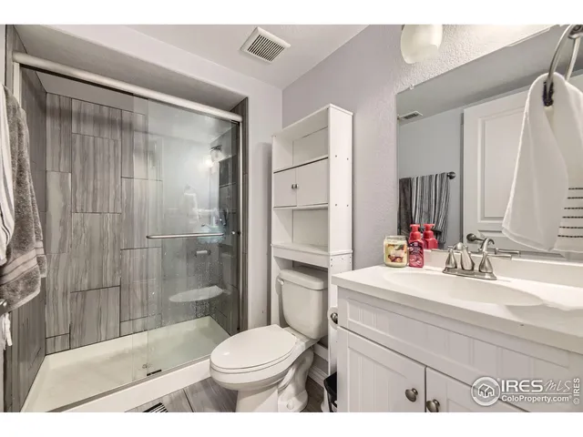 a view of a patio with table and chairs with wooden fence
