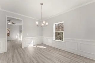 a view of empty room with wooden floor and window