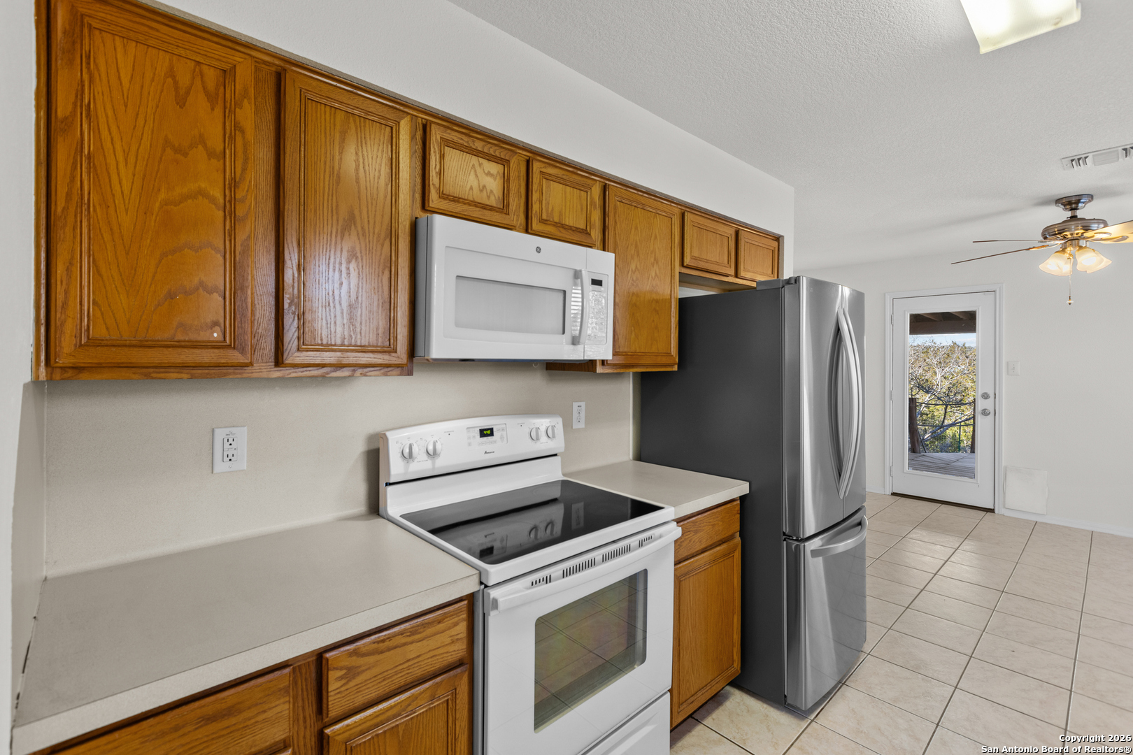 431 Windy Hill Drive Spring Branch, TX 78070 - Photo 16 of 45 a kitchen with stainless steel appliances a refrigerator stove and microwave