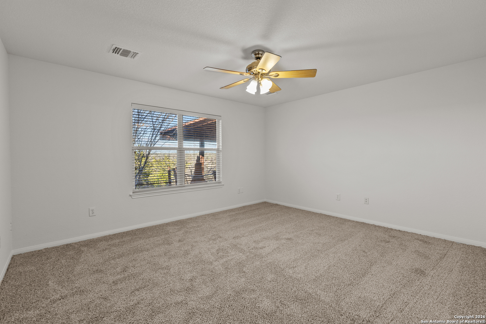 431 Windy Hill Drive Spring Branch, TX 78070 - Photo 18 of 45 an empty room with a window