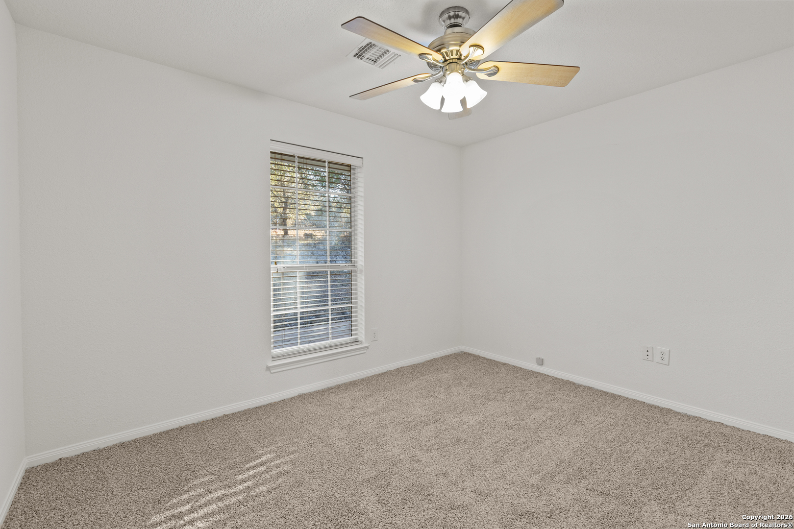 431 Windy Hill Drive Spring Branch, TX 78070 - Photo 21 of 45 an empty room with a window