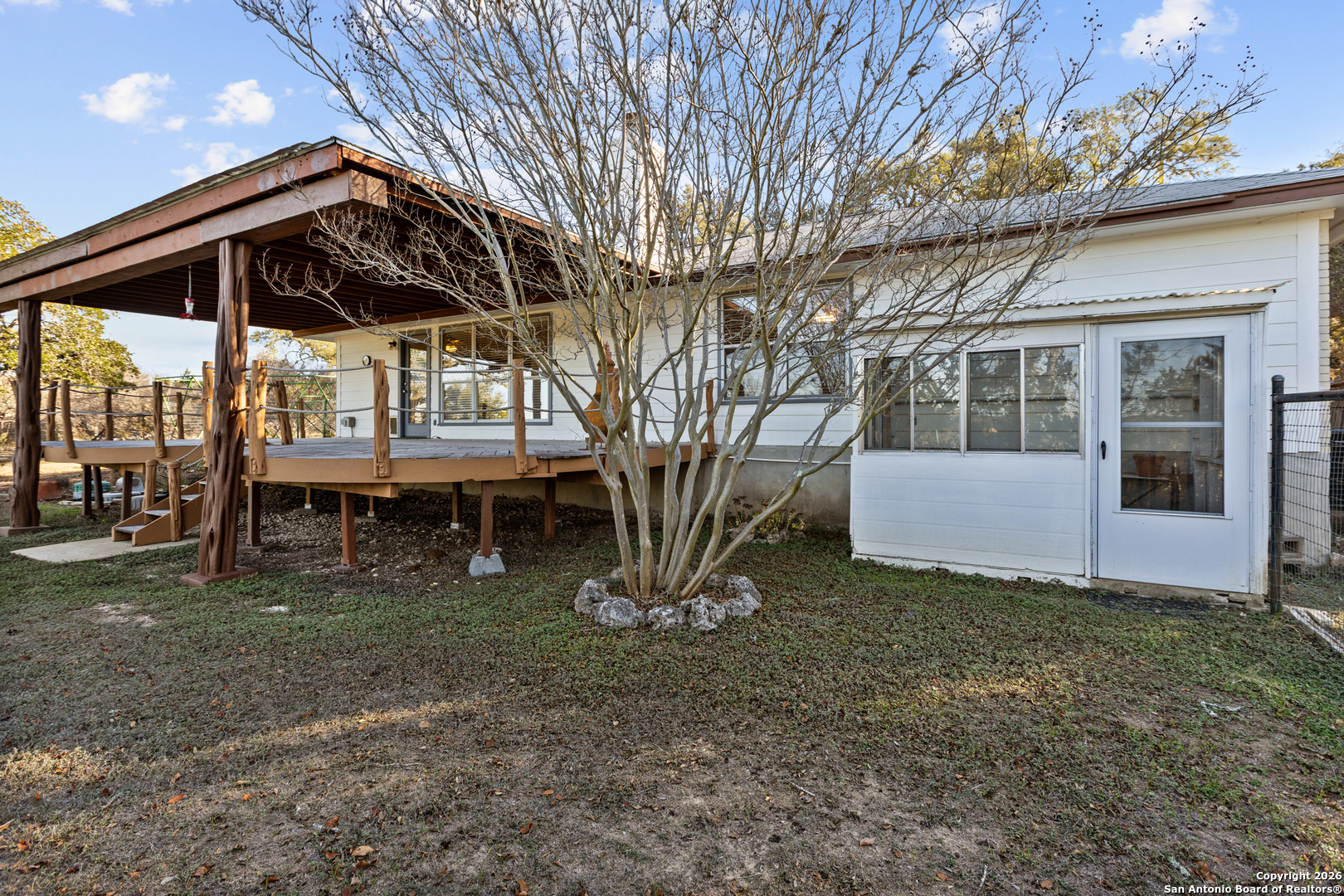 431 Windy Hill Drive Spring Branch, TX 78070 - Photo 29 of 45 a view of backyard with a table and chairs under an umbrella