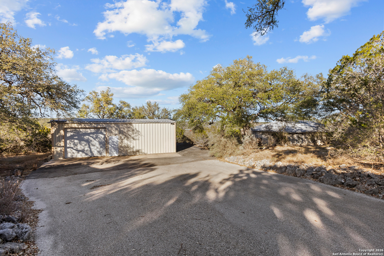 431 Windy Hill Drive Spring Branch, TX 78070 - Photo 34 of 45 a view of a yard with a tree