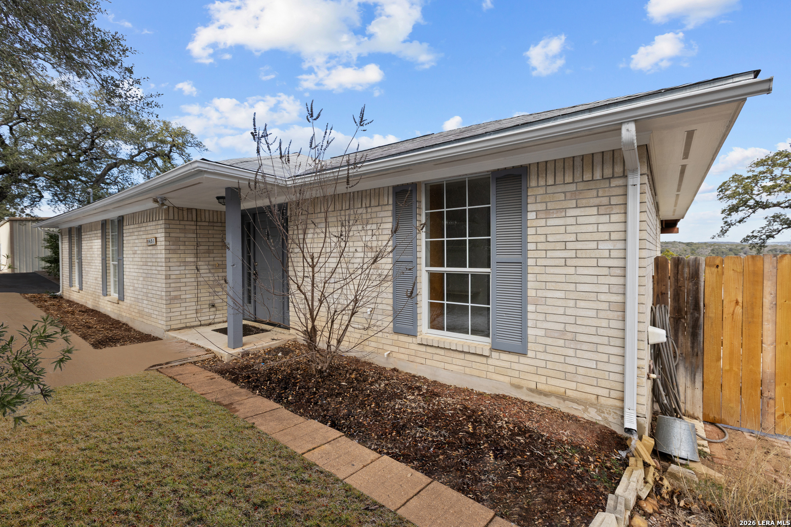 431 Windy Hill Drive Spring Branch, TX 78070 - Photo 4 of 45 a front view of a house with garden
