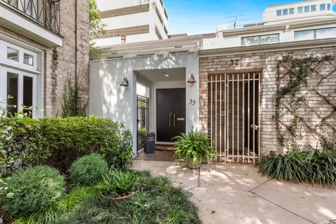 a front view of a building with potted plants