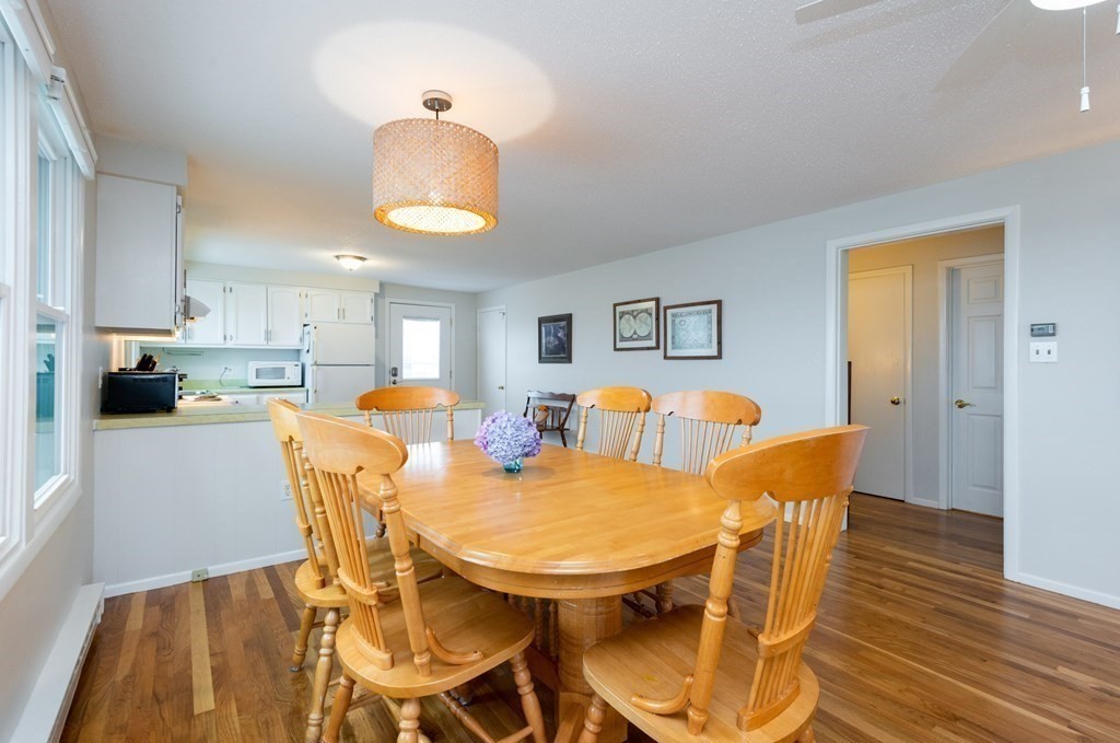 63 River Road Ipswich, MA 01938 - Photo 11 of 31 a view of a dining room with furniture and wooden floor